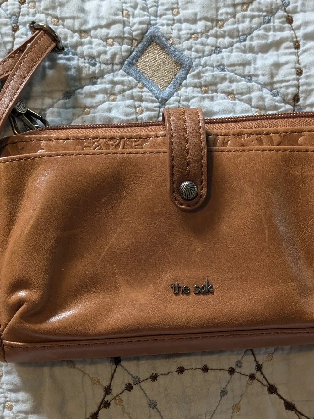 The Sak tan leatherette crossbody wristlet